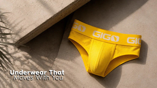 Yellow Gigo brief laid on a stone surface beside the text “Underwear That Moves With You.”